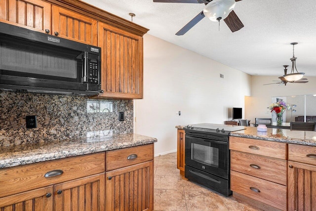 kitchen featuring light stone countertops, backsplash, a textured ceiling, black appliances, and light tile patterned floors