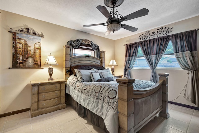 tiled bedroom with a textured ceiling and ceiling fan