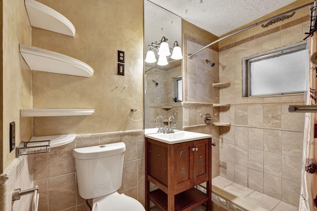 bathroom featuring tile walls, a textured ceiling, toilet, vanity, and curtained shower