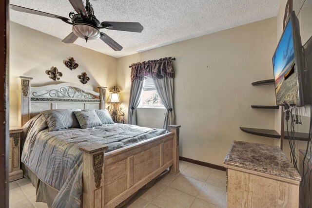 tiled bedroom with a textured ceiling and ceiling fan