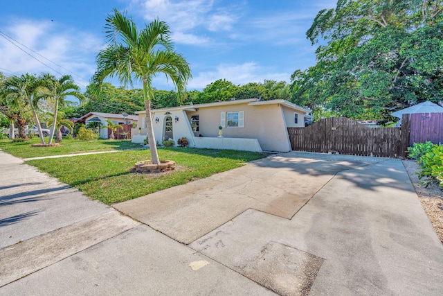 ranch-style home with a front lawn