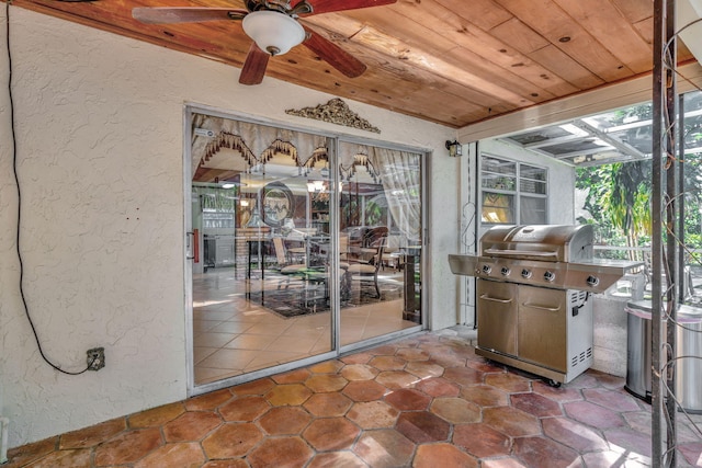 sunroom with wooden ceiling and ceiling fan