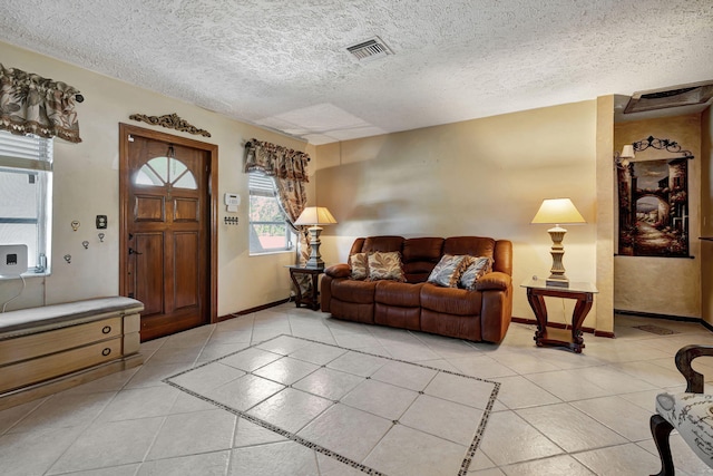 tiled living room featuring a textured ceiling