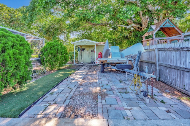 view of patio featuring an outbuilding and a lanai