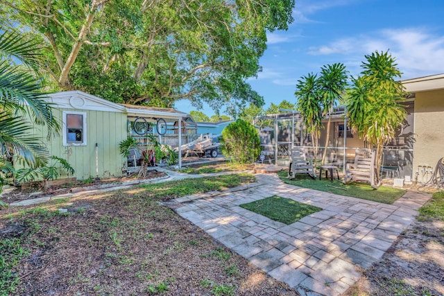 view of yard featuring a shed and a patio