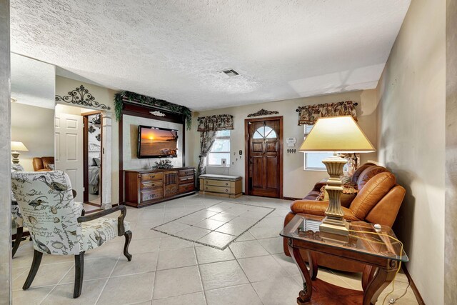 tiled living room with a textured ceiling