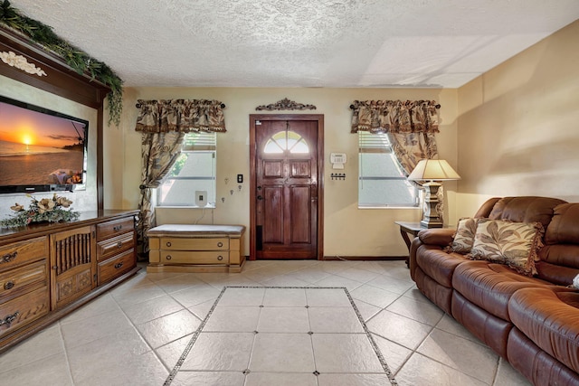 tiled living room with plenty of natural light and a textured ceiling