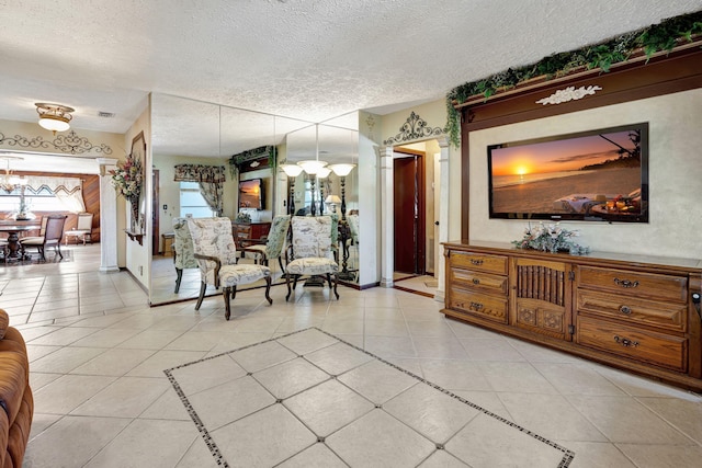 tiled living room featuring a notable chandelier and a textured ceiling