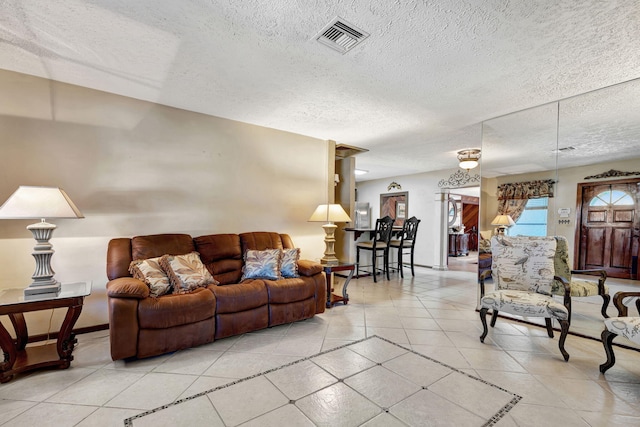 living room with light tile patterned floors and a textured ceiling