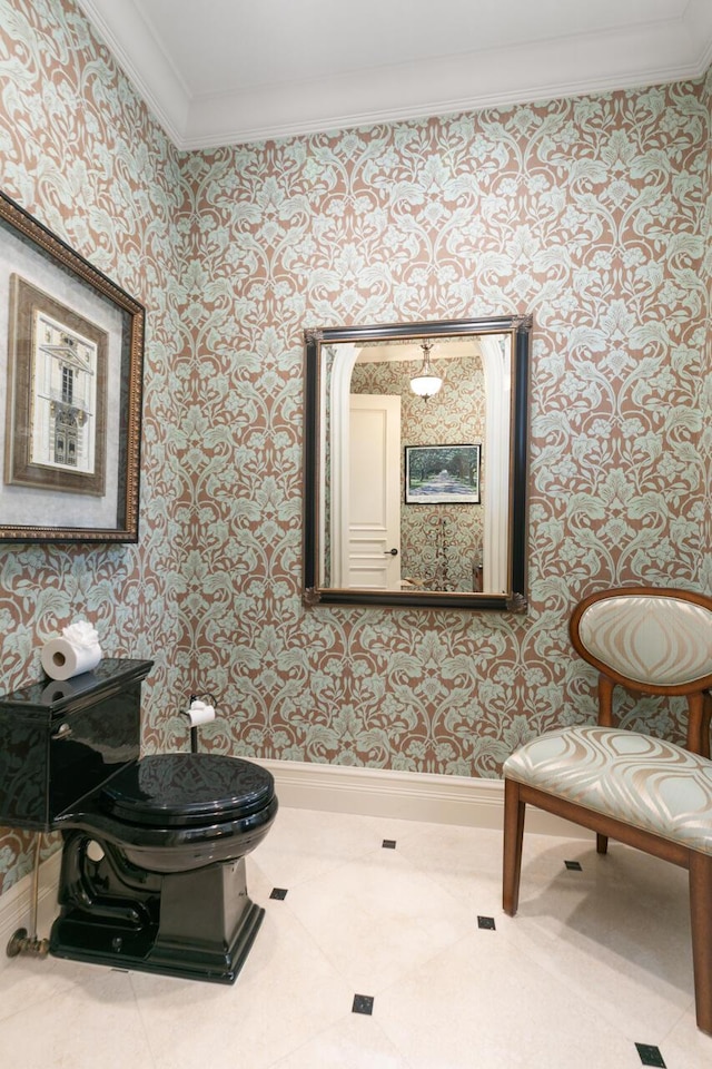 half bath featuring ornamental molding, tile patterned floors, toilet, and wallpapered walls