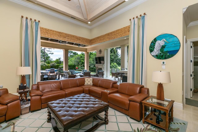 interior space with baseboards, crown molding, and a high ceiling