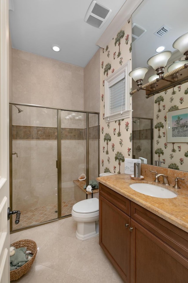 bathroom with a stall shower, vanity, visible vents, and wallpapered walls