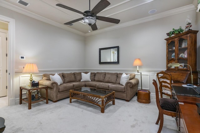 living area with ceiling fan, ornamental molding, visible vents, and light colored carpet