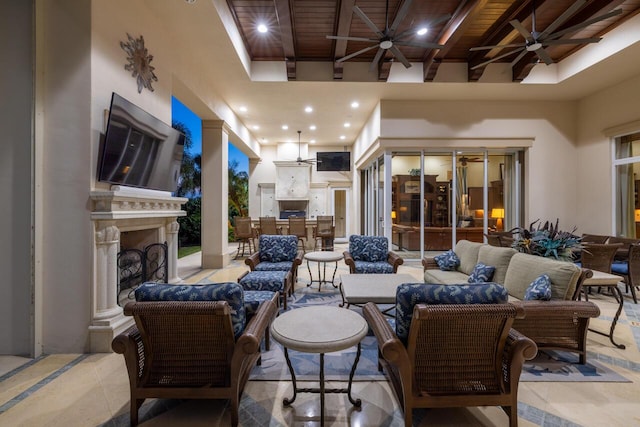 view of patio with an outdoor living space with a fireplace, ceiling fan, and outdoor dining space