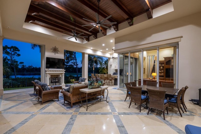 view of patio / terrace featuring outdoor dining space, fence, and an outdoor living space with a fireplace