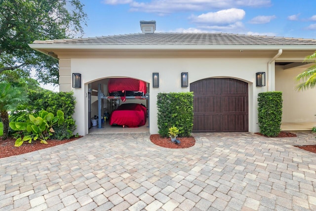 garage featuring decorative driveway