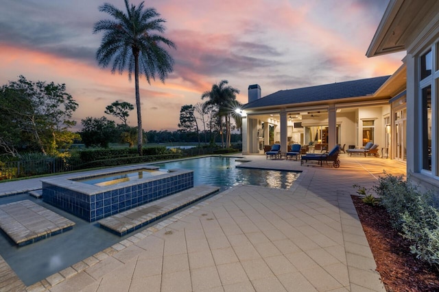 view of swimming pool featuring a patio area and a pool with connected hot tub