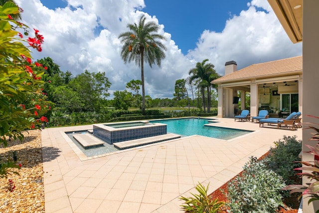 view of swimming pool with a patio and a pool with connected hot tub