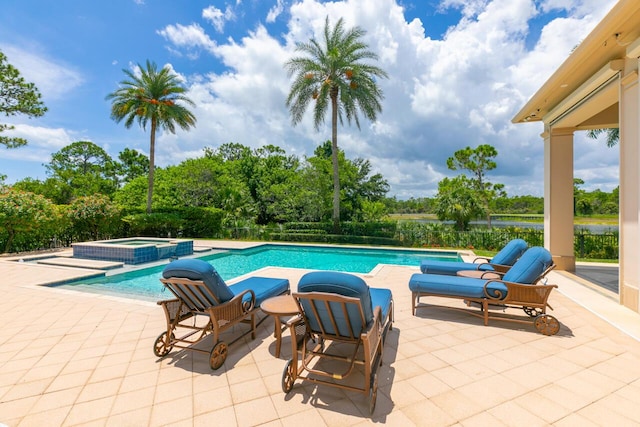 view of swimming pool with a pool with connected hot tub and a patio