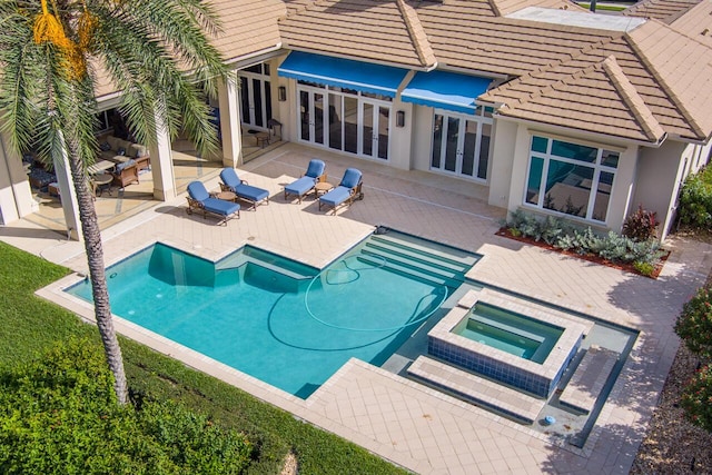 view of pool featuring an outdoor hangout area, a patio area, and a pool with connected hot tub