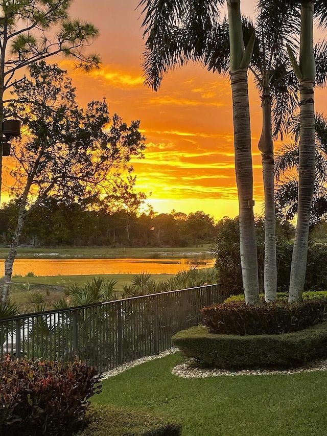 view of property's community featuring a water view and fence