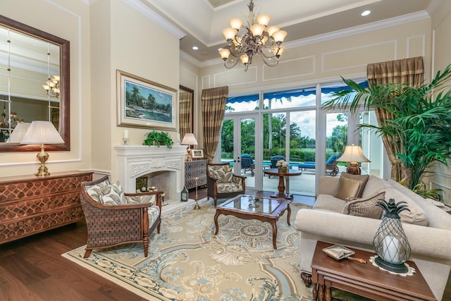 7380 SE Medalist Pl, Hobe Sound, FL 33455 - living area featuring recessed lighting, a chandelier, a fireplace, ornamental molding, and wood finished floors