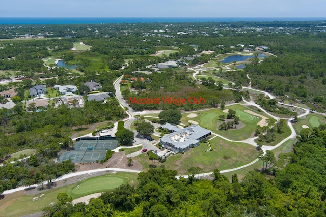 bird's eye view featuring view of golf course, a water view, and a forest view