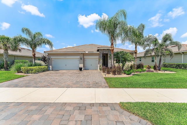 view of front of home with a garage and a front lawn