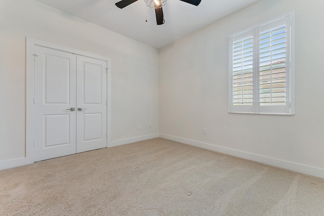 unfurnished room with ceiling fan and carpet floors