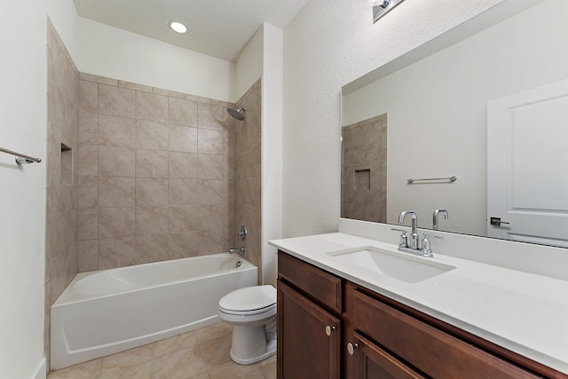 full bathroom featuring tile patterned floors, tiled shower / bath combo, toilet, and vanity