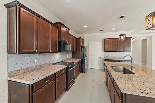 kitchen with stainless steel electric range, sink, hanging light fixtures, and tasteful backsplash