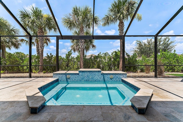 view of swimming pool with a lanai, a patio area, and an in ground hot tub