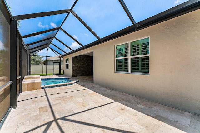 view of swimming pool with a jacuzzi, glass enclosure, and a patio area