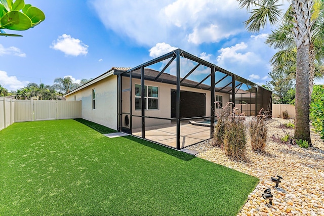 rear view of house featuring a patio, a pool, a lanai, and a lawn