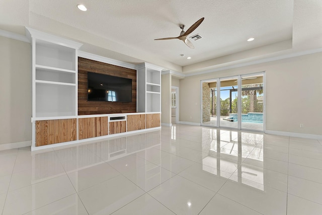 unfurnished living room with built in shelves, a textured ceiling, tile patterned floors, and ceiling fan