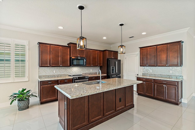 kitchen featuring light stone counters, sink, black appliances, pendant lighting, and a center island with sink