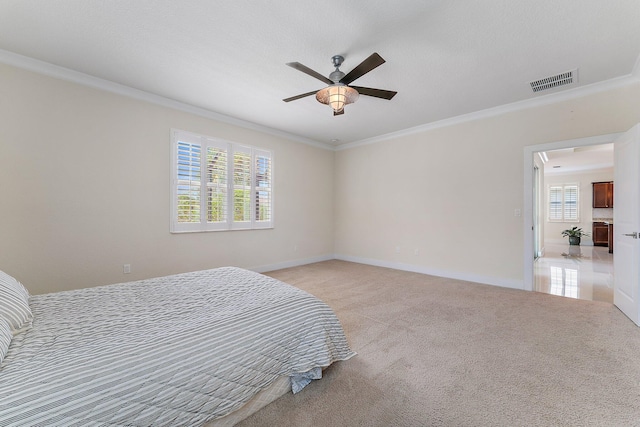 bedroom with ceiling fan, light colored carpet, and ornamental molding