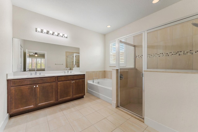 bathroom with tile patterned floors, vanity, and shower with separate bathtub