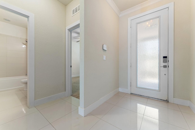 entryway featuring ornamental molding and light tile patterned flooring