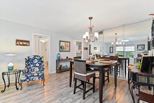 dining space featuring a chandelier and hardwood / wood-style flooring