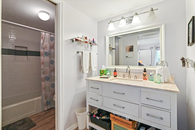 bathroom with vanity, hardwood / wood-style flooring, and shower / tub combo with curtain