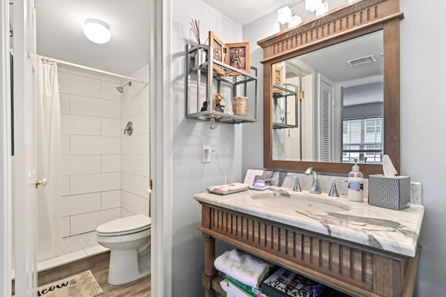 bathroom featuring a shower with curtain, toilet, wood-type flooring, and vanity