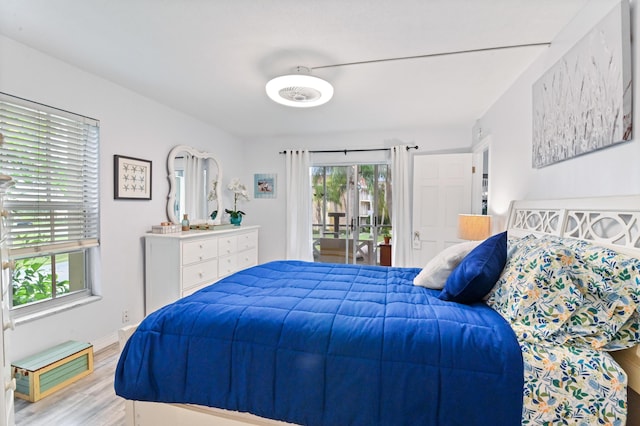 bedroom with access to exterior, ceiling fan, and light wood-type flooring