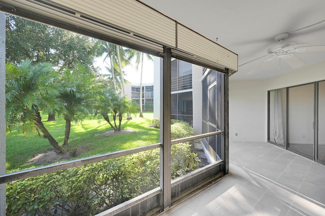 unfurnished sunroom featuring ceiling fan