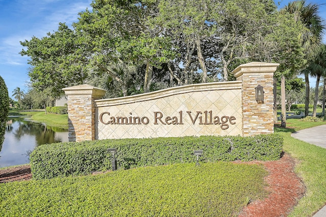 community sign featuring a water view