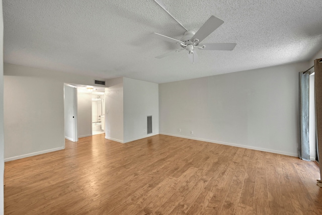 living room with hardwood / wood-style floors, a textured ceiling, and ceiling fan