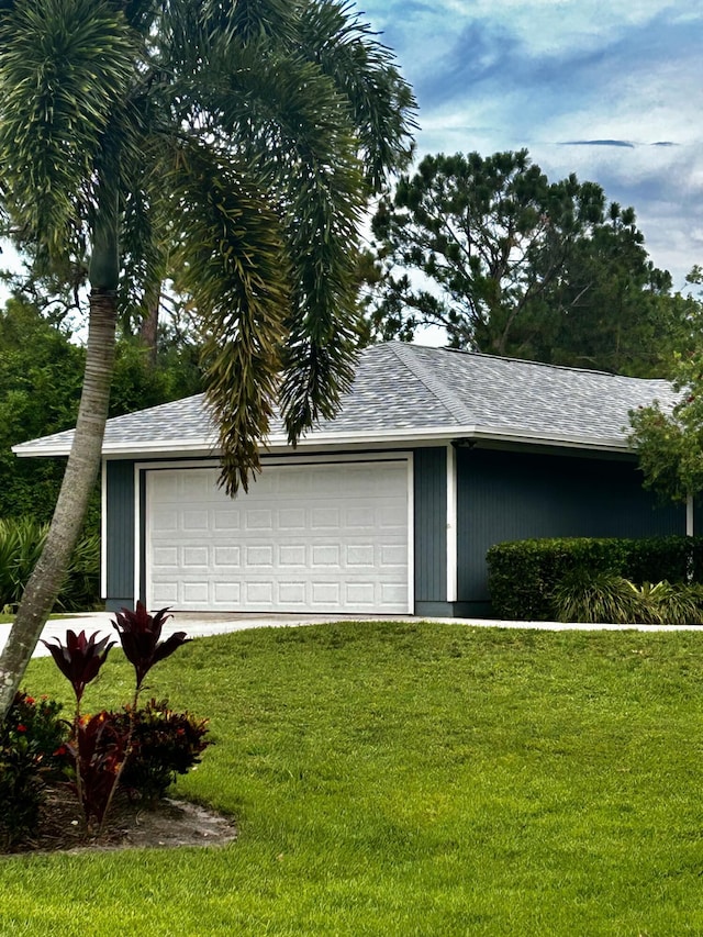 garage featuring a lawn