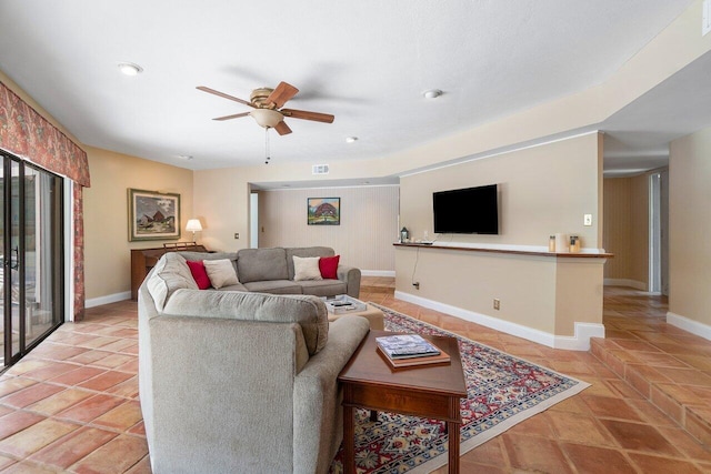 tiled living room featuring plenty of natural light and ceiling fan