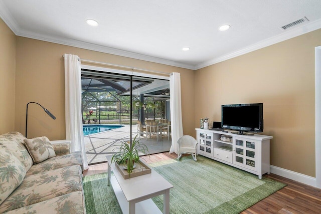 living room featuring crown molding and hardwood / wood-style flooring