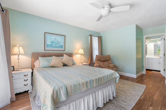 bedroom featuring ensuite bath, ceiling fan, and wood-type flooring